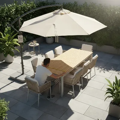 A person meticulously measuring a large outdoor dining table and an extra large patio umbrella, focusing on fit and coverage.